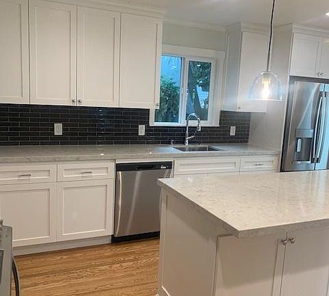 kitchen with new flooring, stainless steel appliances