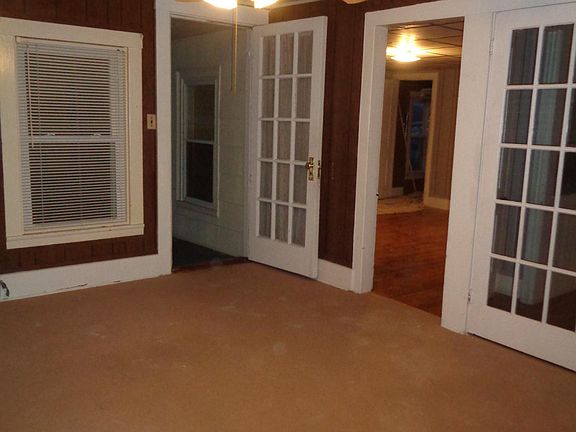 Living room with ceiling fan and beautiful french doors that