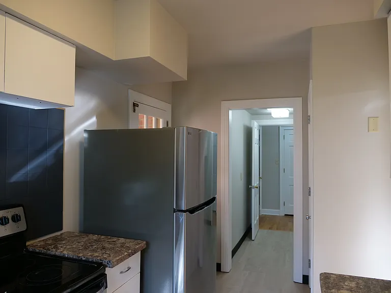 Spacious kitchen with new flooring and brand new fridge.