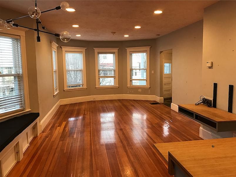 View of living room, dining area (left) and built in desk (right).