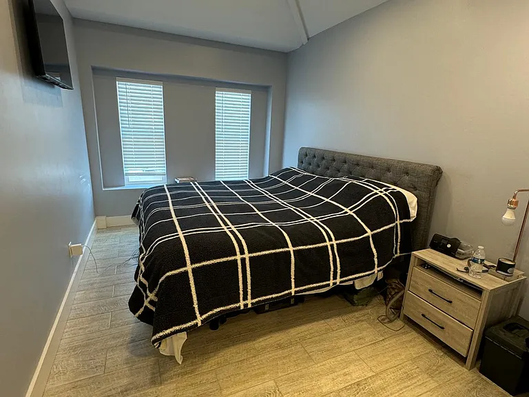 master bedroom front king sized beds, bedside tables and mounted 42" tv.