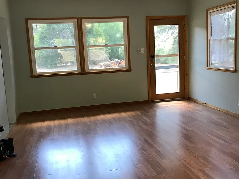 Large living room with Energy Star celiing fan, dimmable overhead light, full length glass door and screen door.