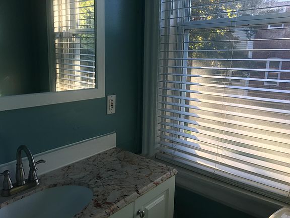 Large bathroom with tub and window