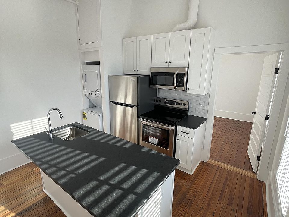 Kitchen with SS appliances and solid surface countertops.
