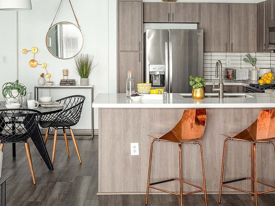 Apartment Kitchen with Stainless Steel Appliances, quartz counters and wood floors.
