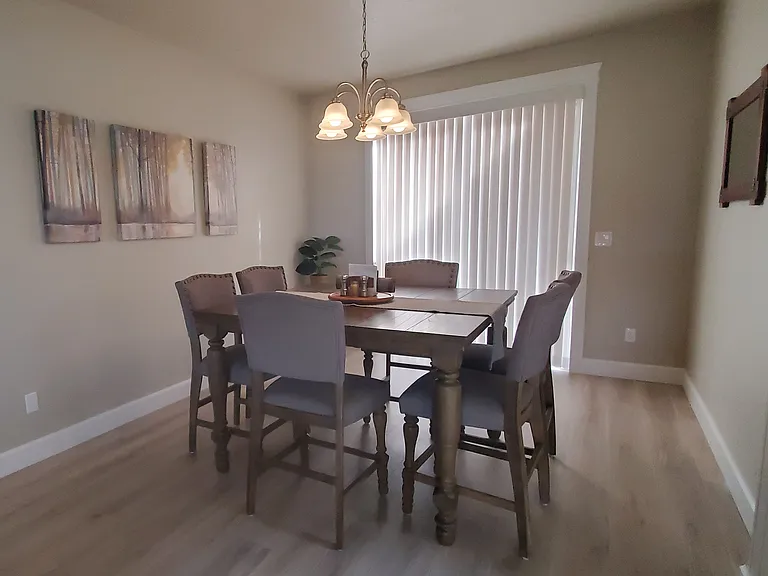 DINING ROOM WITH SLIDING WINDOW TO FRONT PATIO.