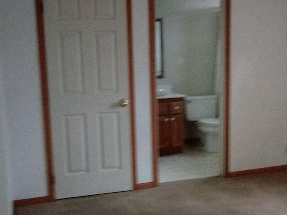 Master bedroom shows bathroom access and walk in closet. Two windows not shown overlooking back yard.
