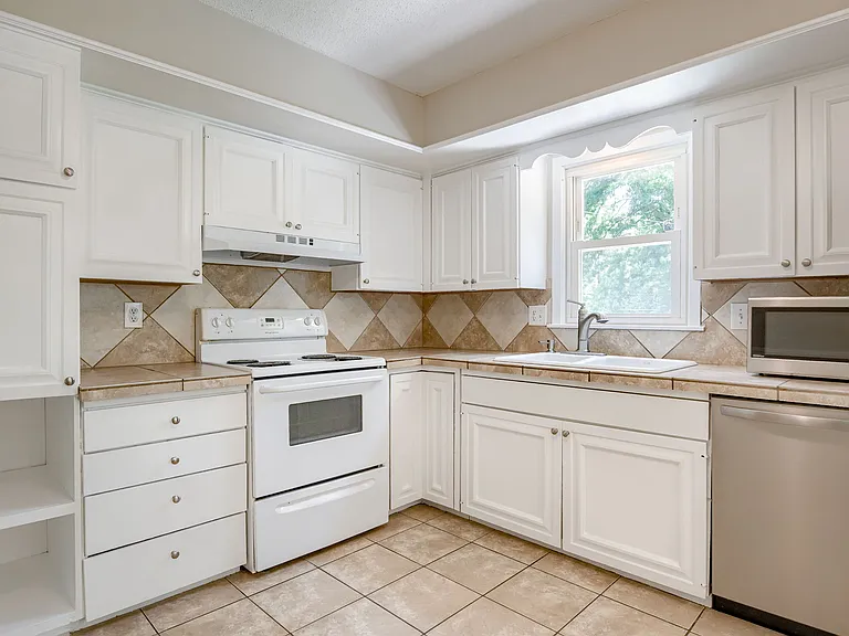 Kitchen sink overlooks backyard + patio