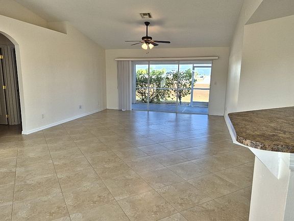 living room with sliders to screen lanai
