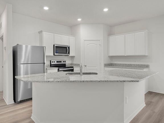 The kitchen has a large island that will be perfect for you and your family to gather around