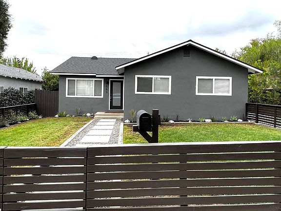 Front View: Fenced green yard