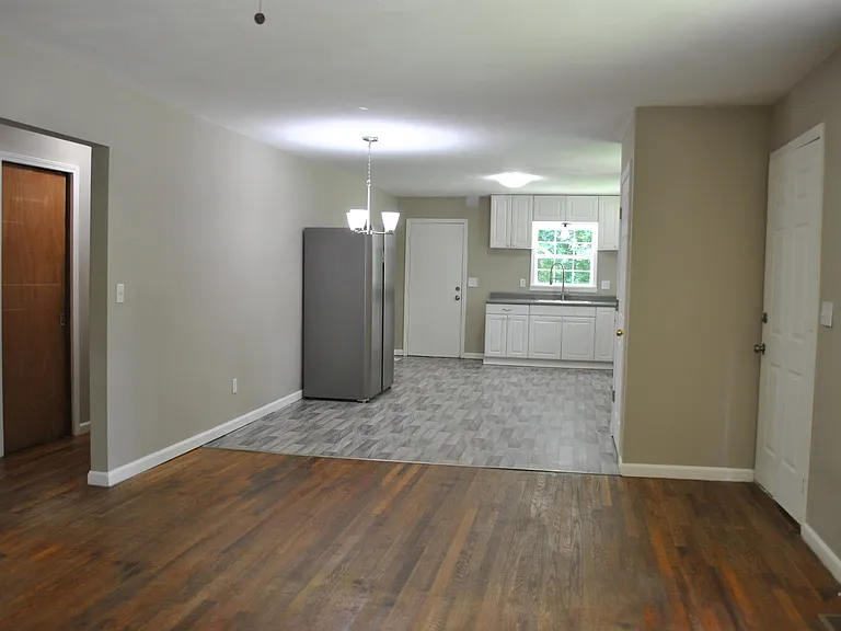Open Concept Living, Dining & Kitchen with pantry and entrance from covered front porch