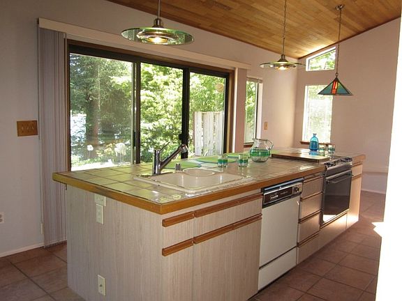 This open and bright island kitchen opens to the patio with a view of the lakefront. What a great area to entertain!