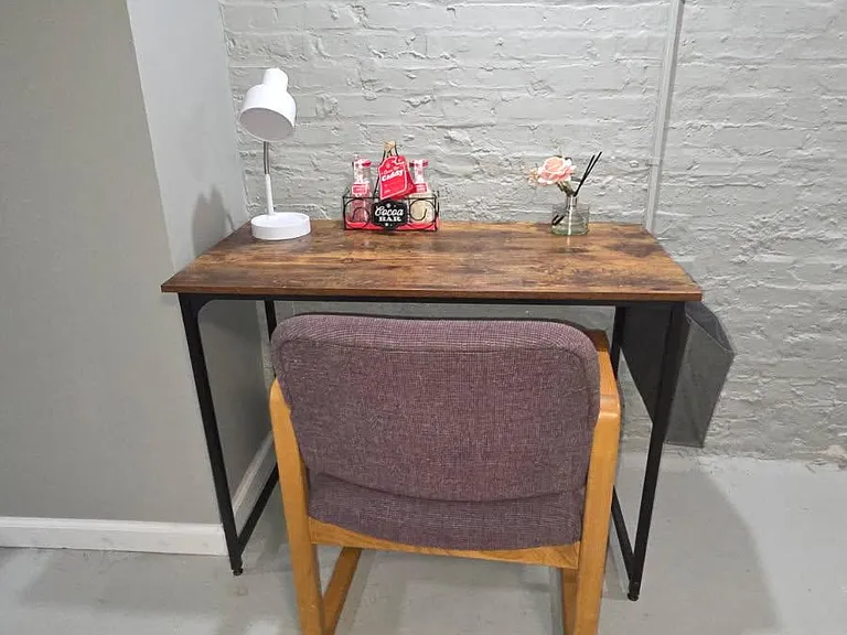 Dedicated desk nook with task lighting and a comfortable chairideal for remote work, studying, or a personal setup.