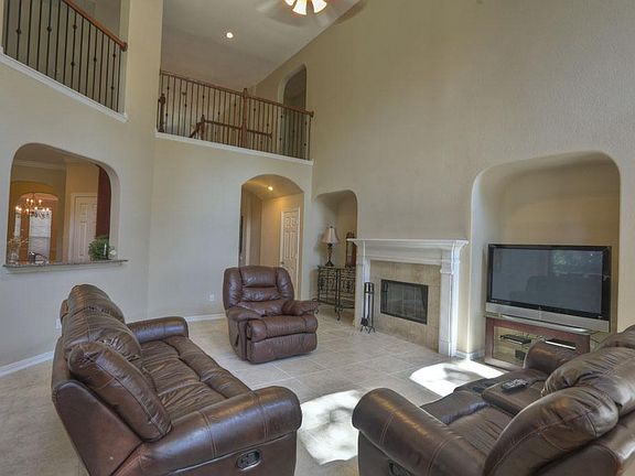 Living Area with Large Windows OverLooking BackYard and Gas FirePlace for Cool Evenings.
