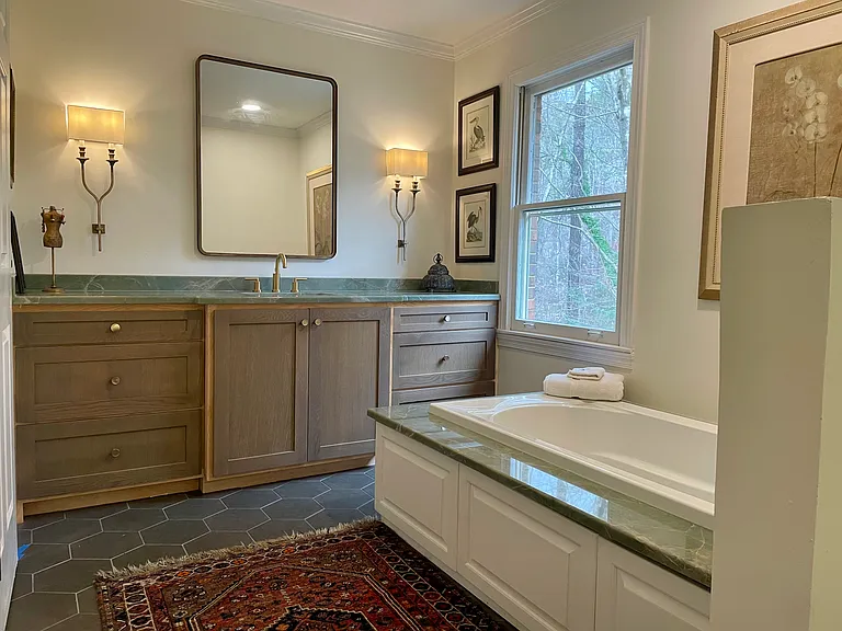Large en-suite master bath. Deep tub, lovely quartz countertops and tub surround.