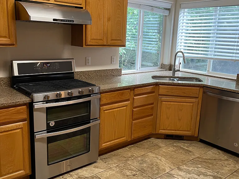 Tile in kitchen and laminated wood in the family room.