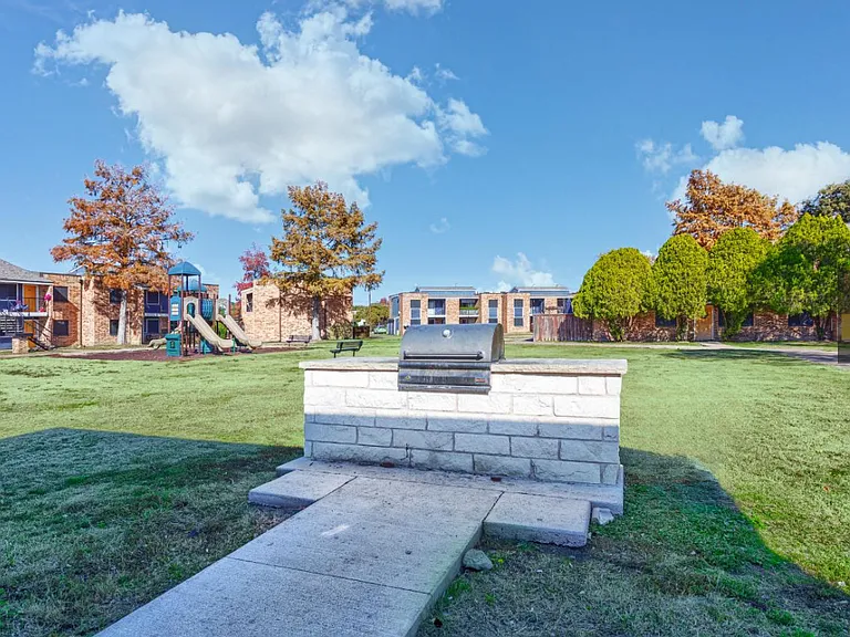 Fire up the grill at our modern barbecue station surrounded by open green space and mature trees _ ideal for entertaining and dining al fresco right outside your home.