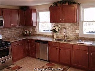 Large kitchen with granite countertops, stainless steel appliances
