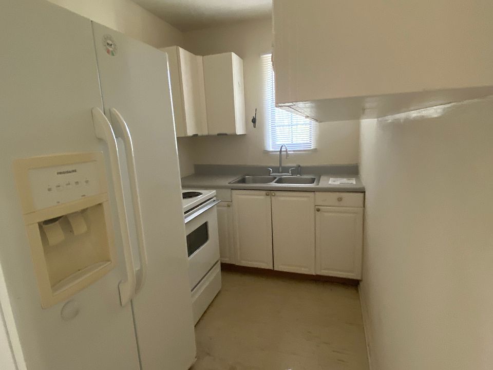 Kitchen- Fridge has been upgraded to a smaller, new fridge that fits the space better