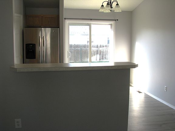 Standing in the living room looking toward the kitchen * eating area towards the sliding back door