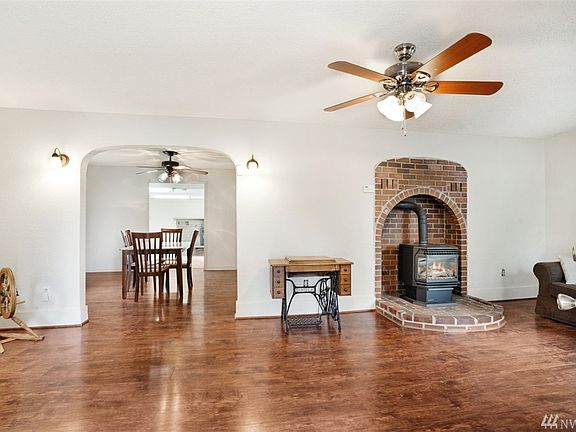 Gleaming laminate floors welcome you to the open living area with a cozy gas fireplace for chilly fall days
