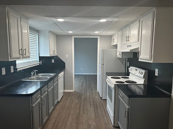 Galley kitchen, updated canned lighting for a very bright open cooking area. Can walk through kitchen to living room area