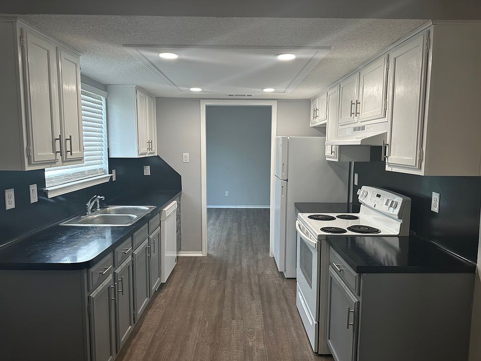 Galley kitchen, updated canned lighting for a very bright open cooking area. Can walk through kitchen to living room area