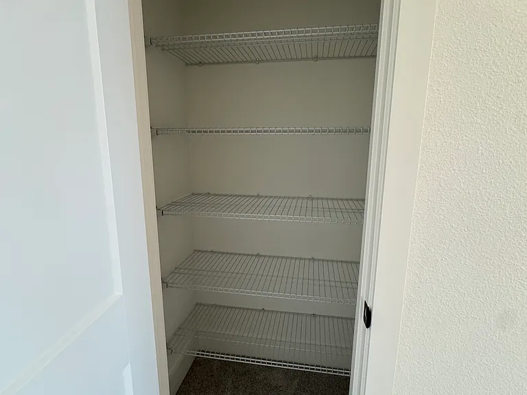 Full closet right in front of the laundry closet