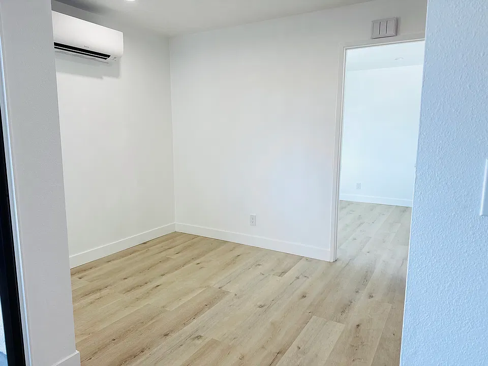 Dining room area with door to bedroom.