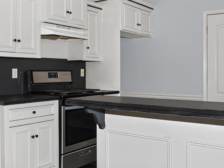 Kitchen with a natural gas stove.