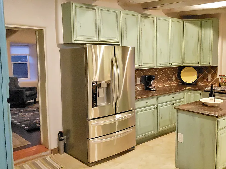 Kitchen w/ Island, stone countertops, and lots of cabinets