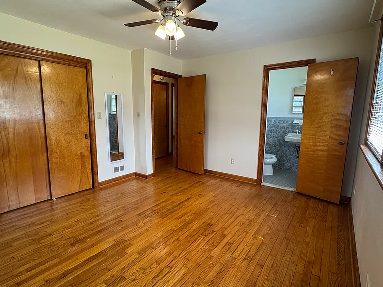 Primary bedroom with private half bath and large closet.