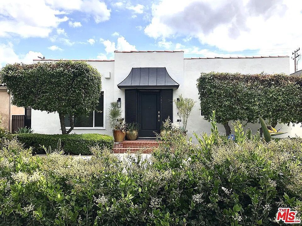 Large entrance door to walk you through a gorgeous mid-century fireplace