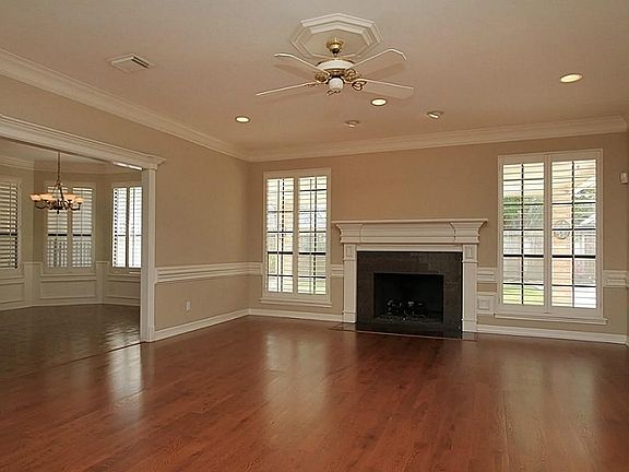 Large den with gaslog fireplace, crown molding, and chair molding.