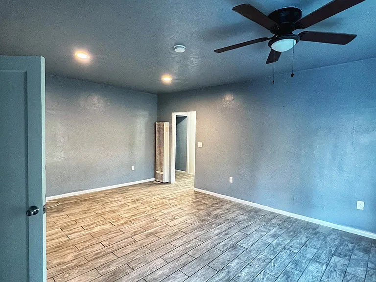 Living room area with closet and entrance way to bedrooms/bathrooms
