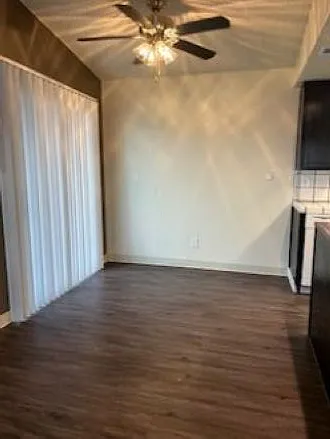 Dining area with ceiling fan and sliding door onto deck