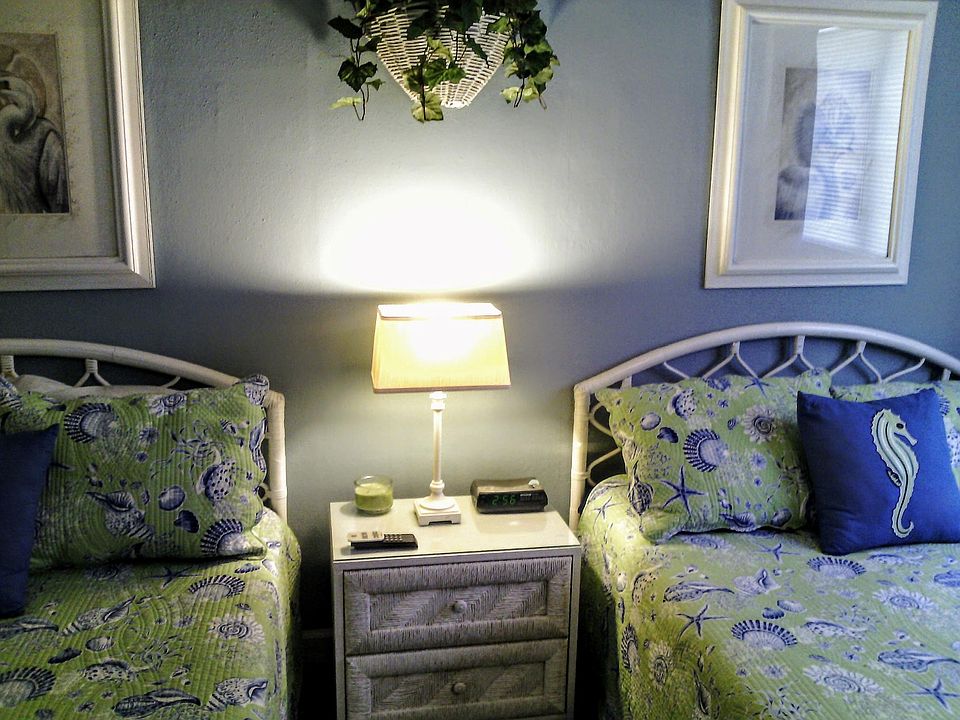 Large bedroom has two double beds including bedding.