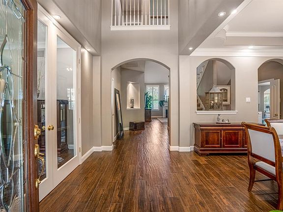 Impressive glass lead front door leads to a 2 story entry with gleaming wood-like plank tile flooring throughout.