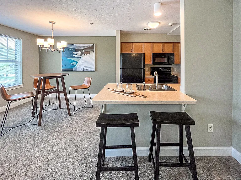 View of well equipped kitchen with breakfast bar and dining area