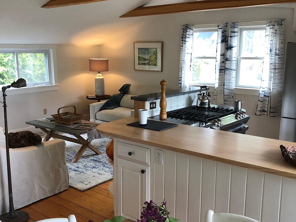 Open concept living, dining, kitchen with cathedral ceiling.