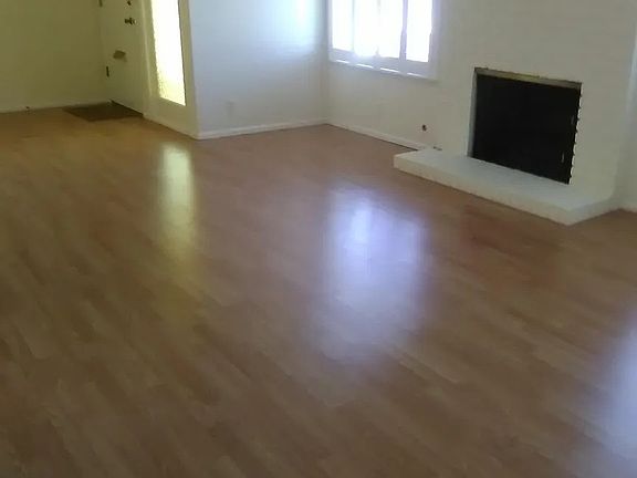 living room looking toward foyer at front door and long vertical window at near door