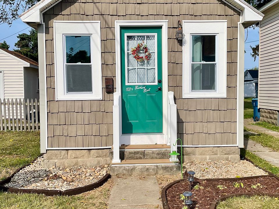 Exterior view of tiny house. Notice new windows and front door!