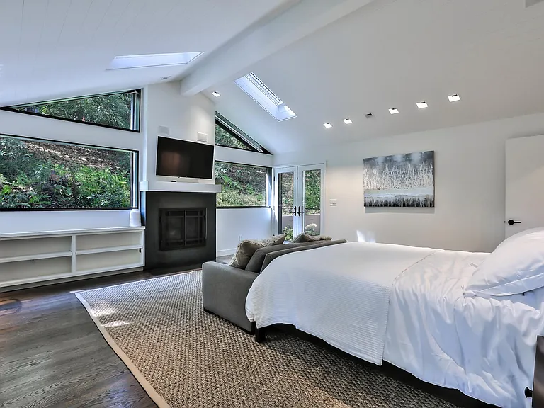 master suite with gas-lit fireplace, desk space and access t