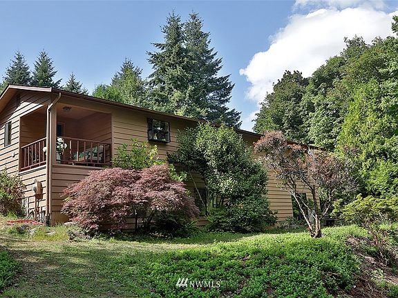 View from the back of the house. Sweet covered porch, window to the right of the porch is the kitchen sink window. 