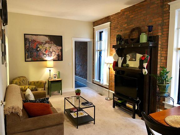 Living room featuring brick wall