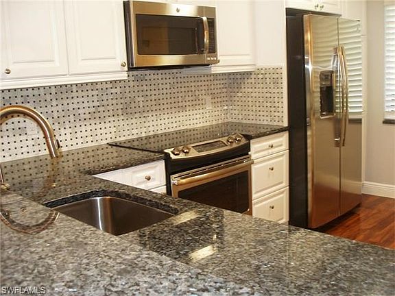 A large one bowl deep stainless sink with in counter start button for garbage disposal is another high end feature.