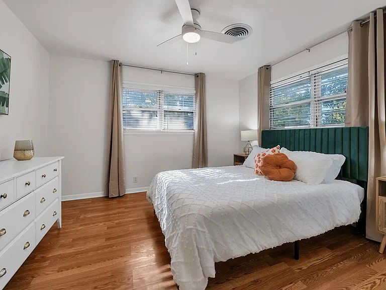 Comfortable secondary bedroom with queen bed and coded door lock for security.