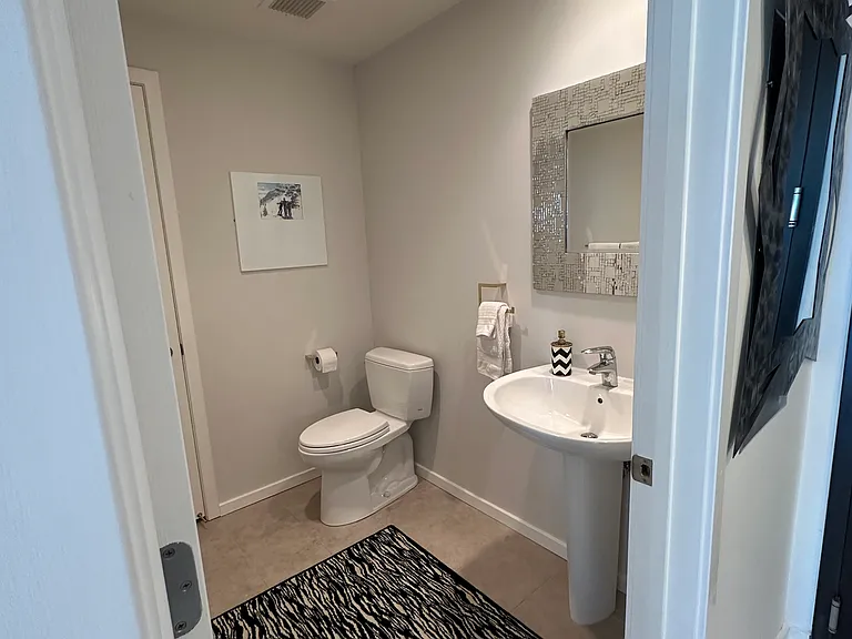 Half bath with custom built in storage closet