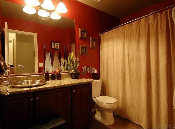 Bathrooms feature slab granite and vessel sinks